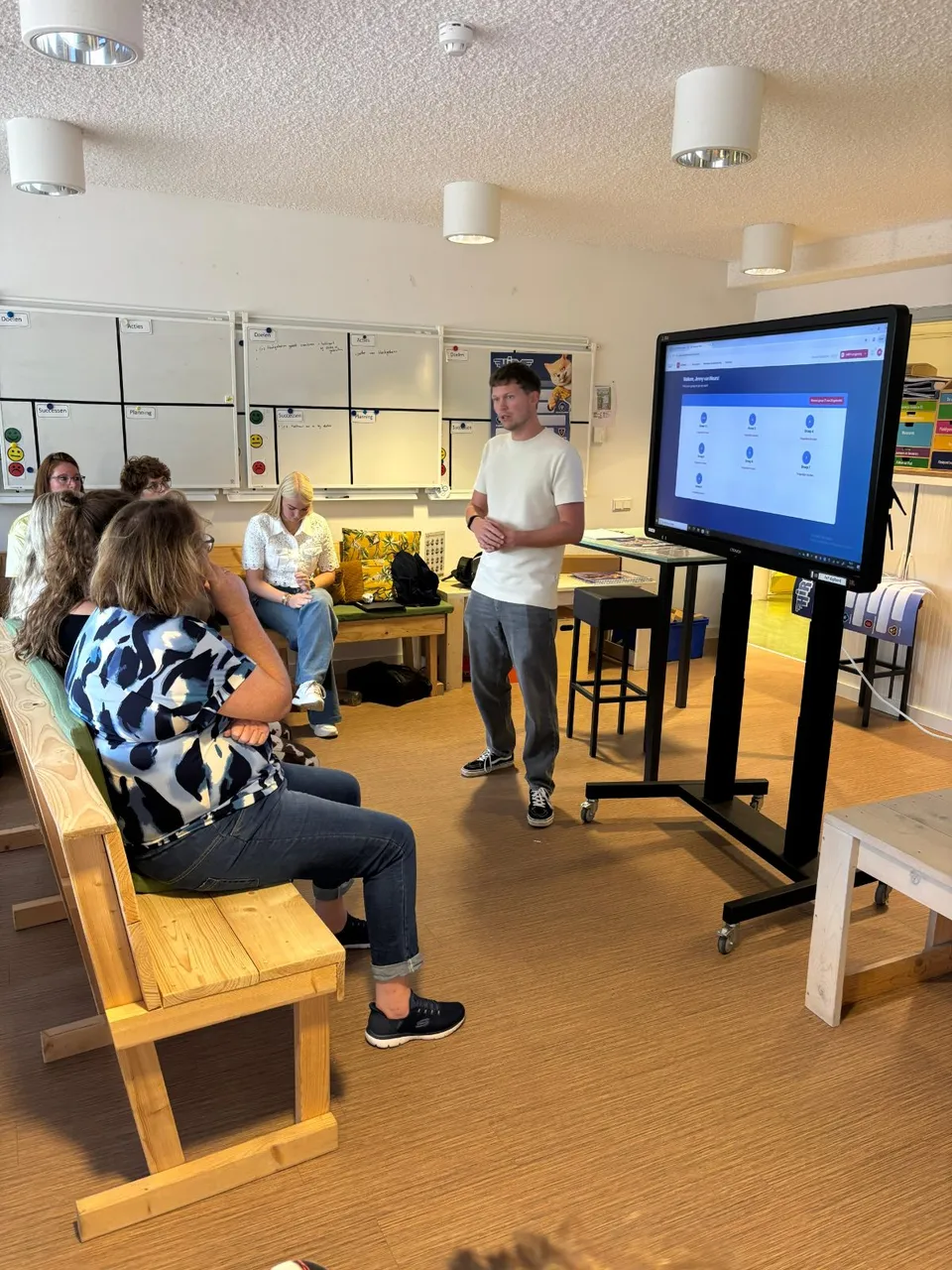 Bart van HiRO geeft uitleg aan het team van De Bloeiende Perelaar bij het digibord